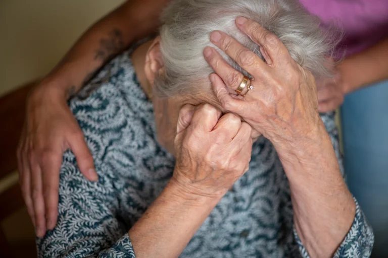 Elderly lady in crisis being comforted - Fluid Senior Transitions